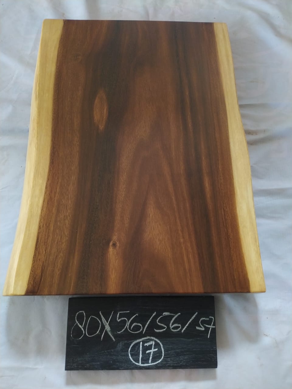 Top view of suar wood slab 0017-565657 with live edge shape and warm brown natural wood grain, solid single-piece countertop.
