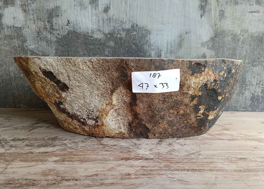 Front side of 18×13 inch river stone sink showing reddish natural exterior and curved profile
