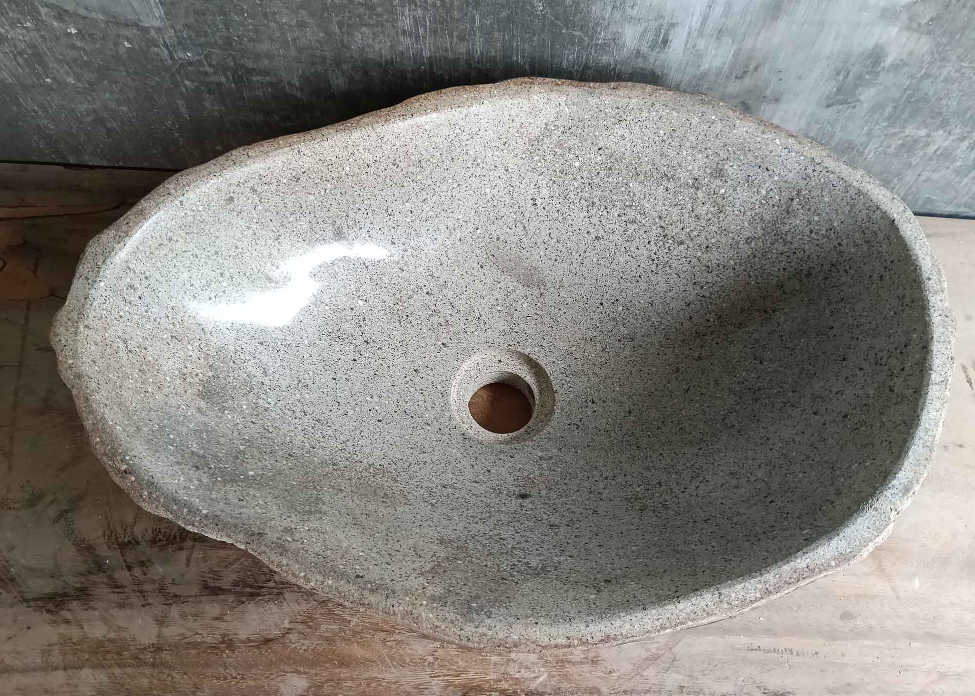 Top view of 18×13 inch light gray river stone sink with boat-like oval shape
