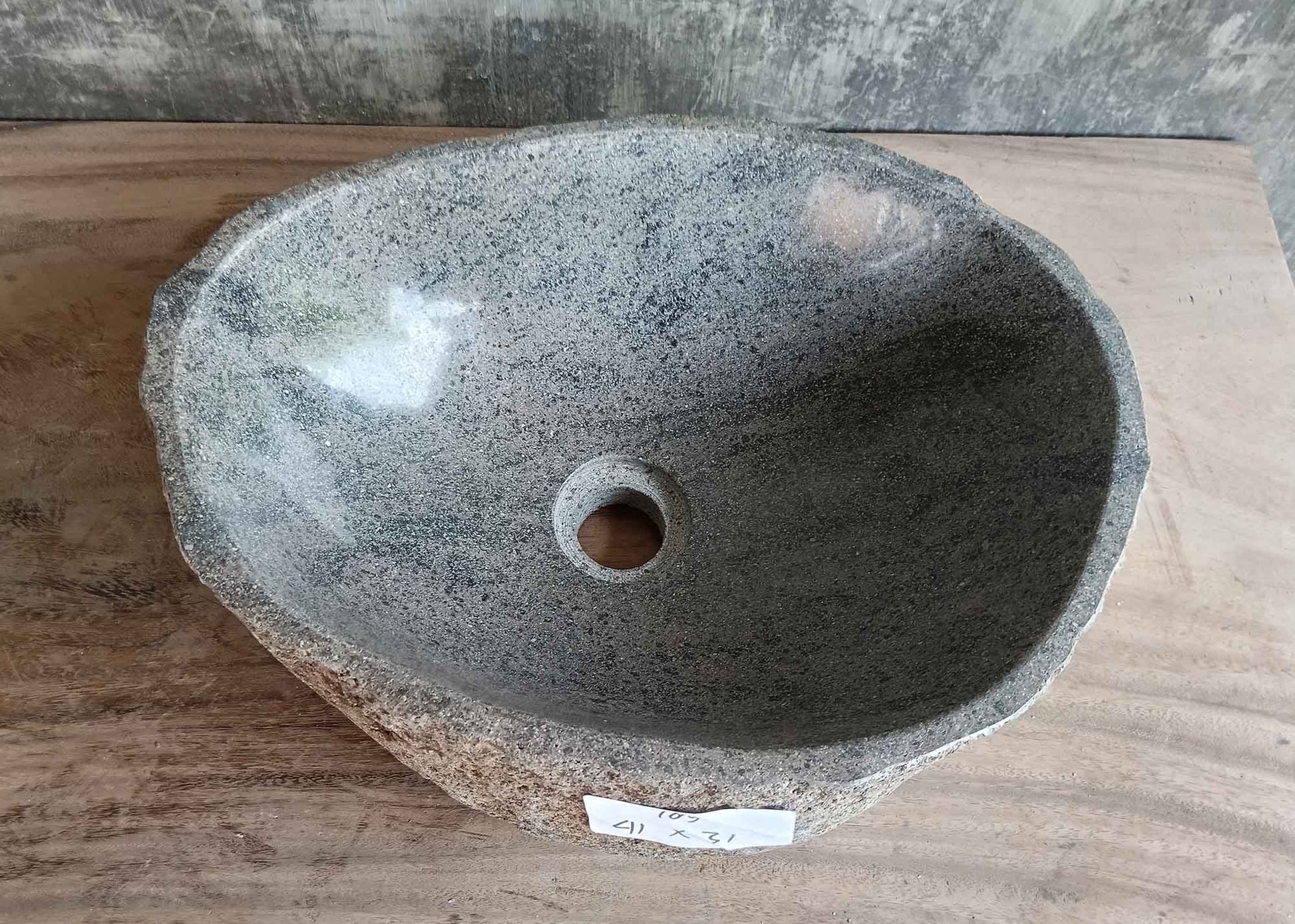 Top view of 16×12 inch gray river stone sink with interior swirls and oval shape
