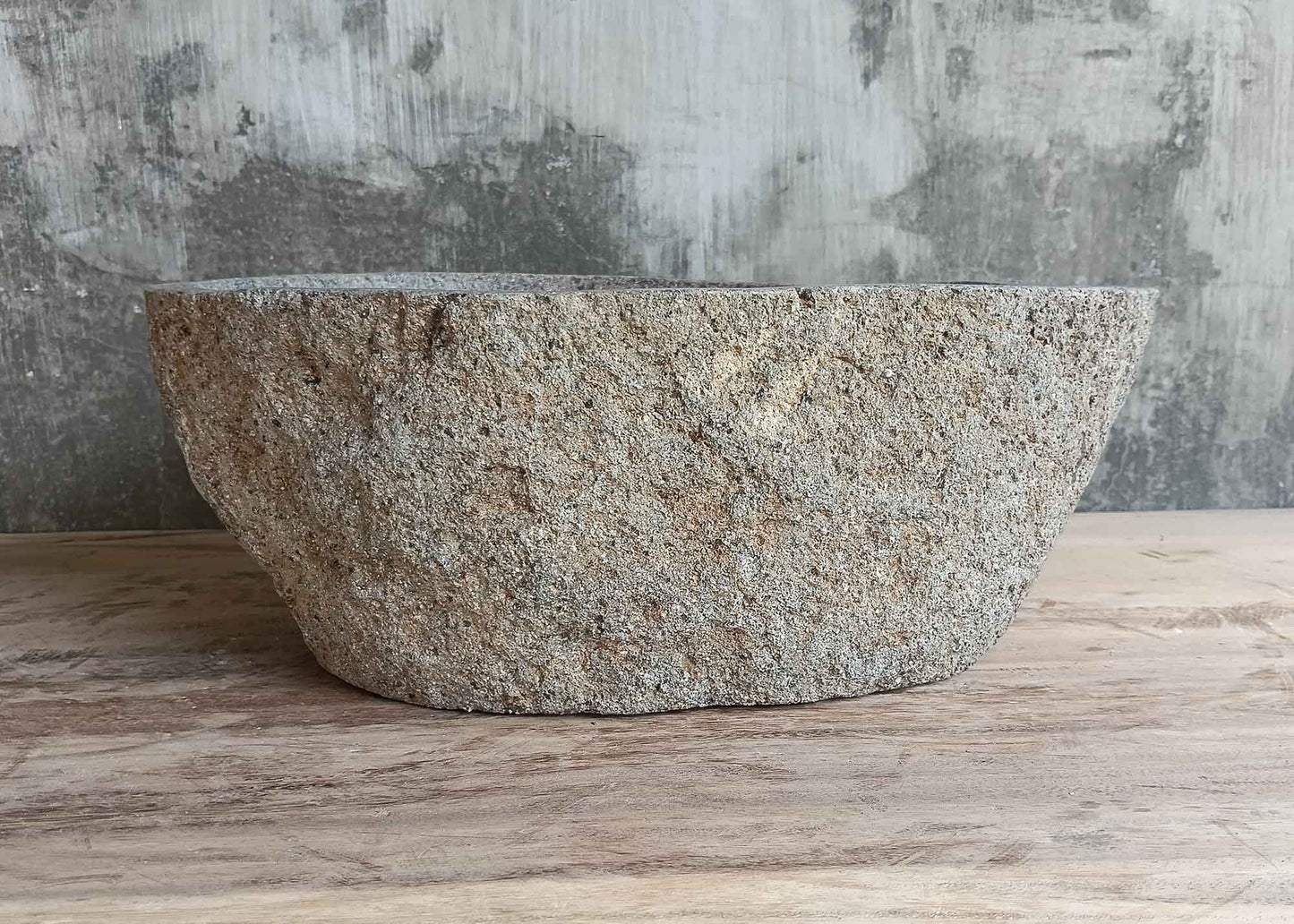 Front side of 16×12 inch handcrafted river stone sink with gray raw exterior and boat-like silhouette
