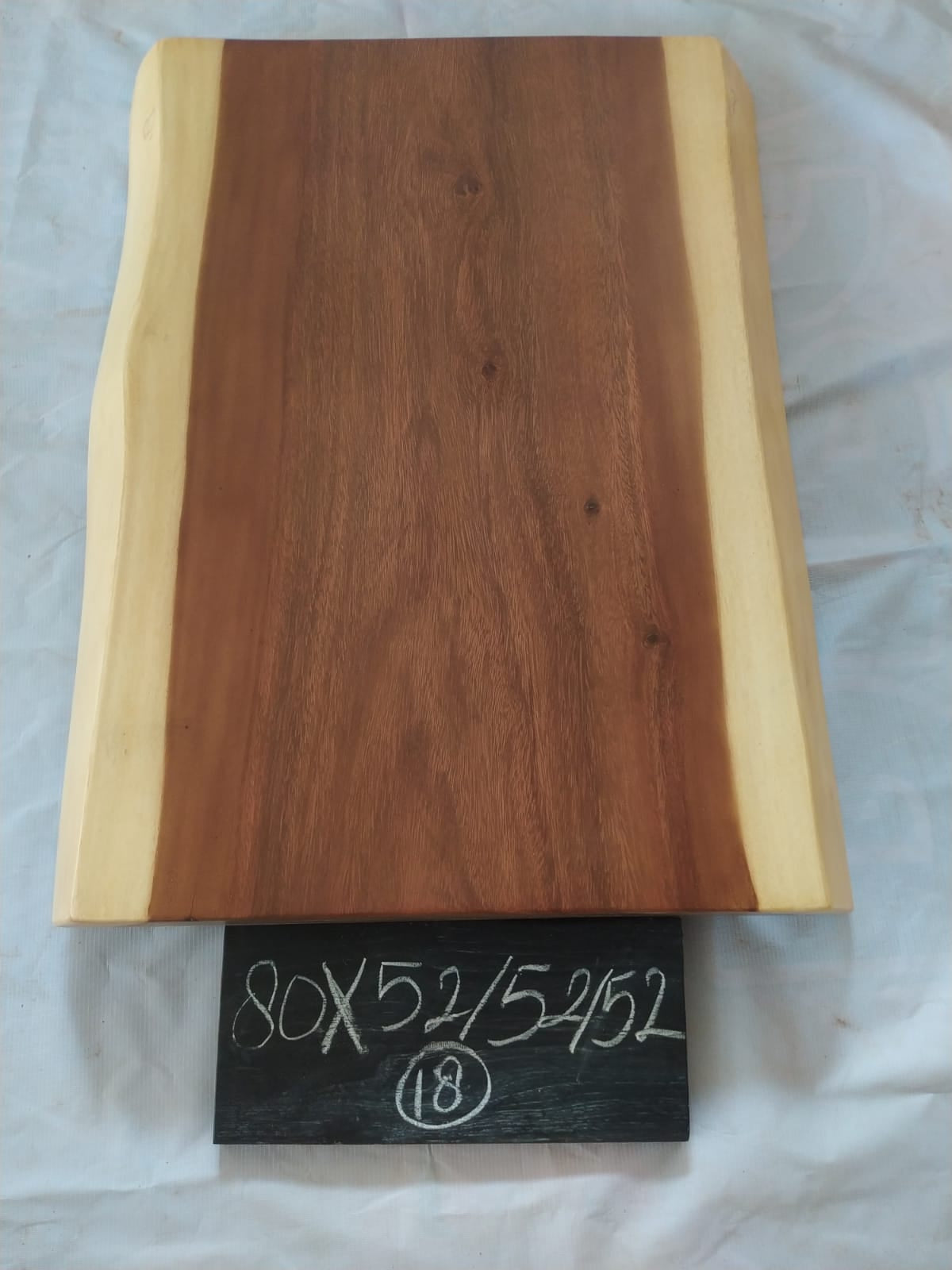 Top view of suar wood slab 0018-525252 with live edge shape and warm brown natural wood grain, solid single-piece countertop.
