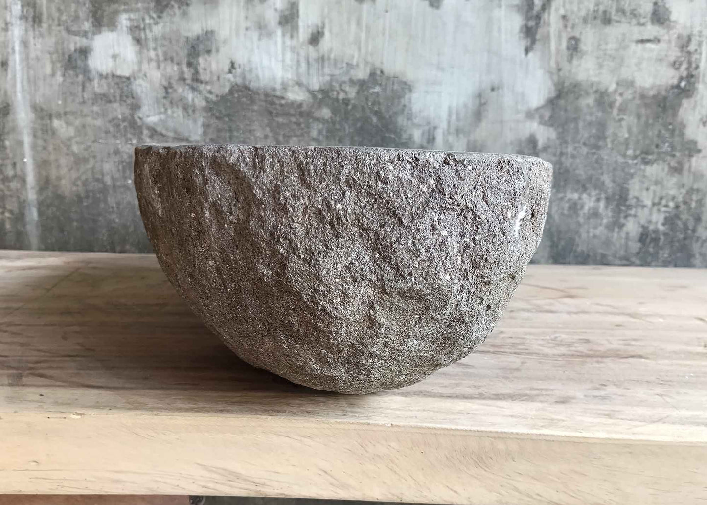 Left side view of 18×12 inch brown river stone sink with natural boat-shaped contour
