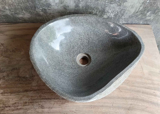 Top view of 17×14 inch handcrafted gray river stone sink with irregular interior
