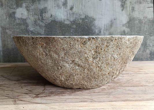 Front view of 17×14 inch light stone sink showing smooth curve and raw exterior
