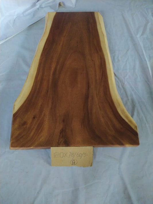 Top view of suar wood slab 0001-786051 with long tapered live edge shape and rich brown natural wood grain, solid single-piece countertop.
