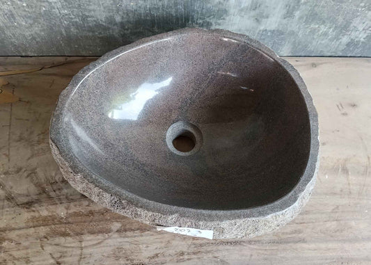 Top view of 16×13 inch brown river stone sink with polished volcanic interior and oval shape
