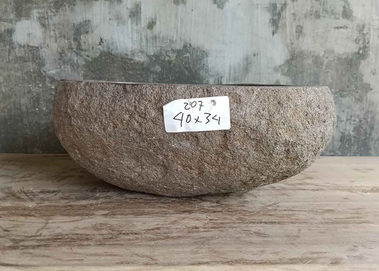 Front side of 16×13 inch handcrafted brown stone sink with boat-like profile and raw finish
