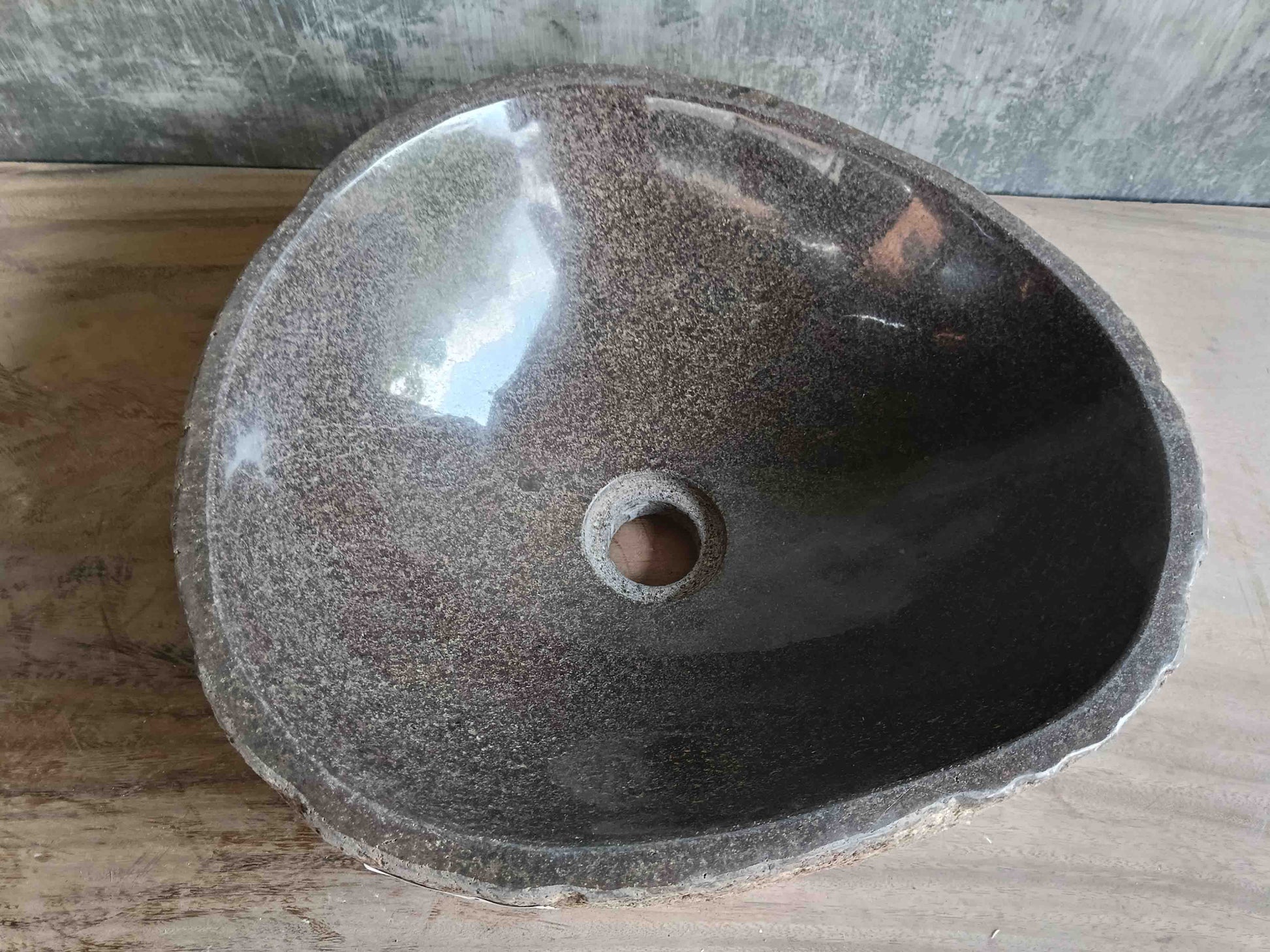 Top view of handcrafted brown 15×14 inch river stone sink in triangular-rounded form
