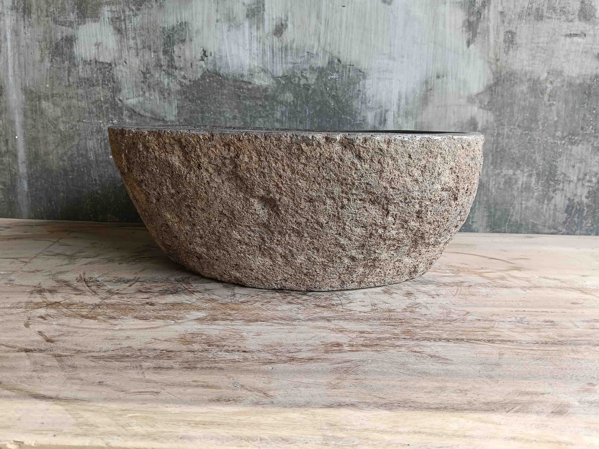 Side view of 15×14 inch brown river stone sink installed in countertop
