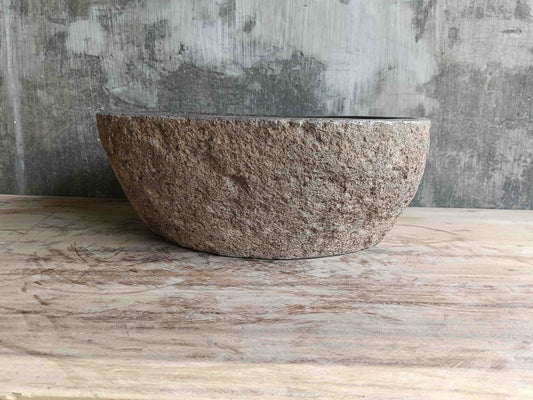 Side view of 15×14 inch brown river stone sink installed in countertop

