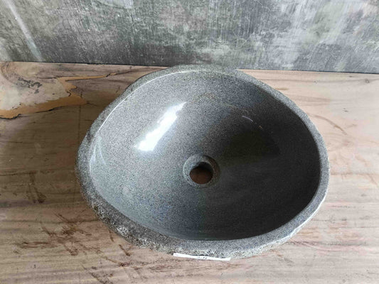 Top view of handcrafted grey 15×13 inch river stone sink in oval form
