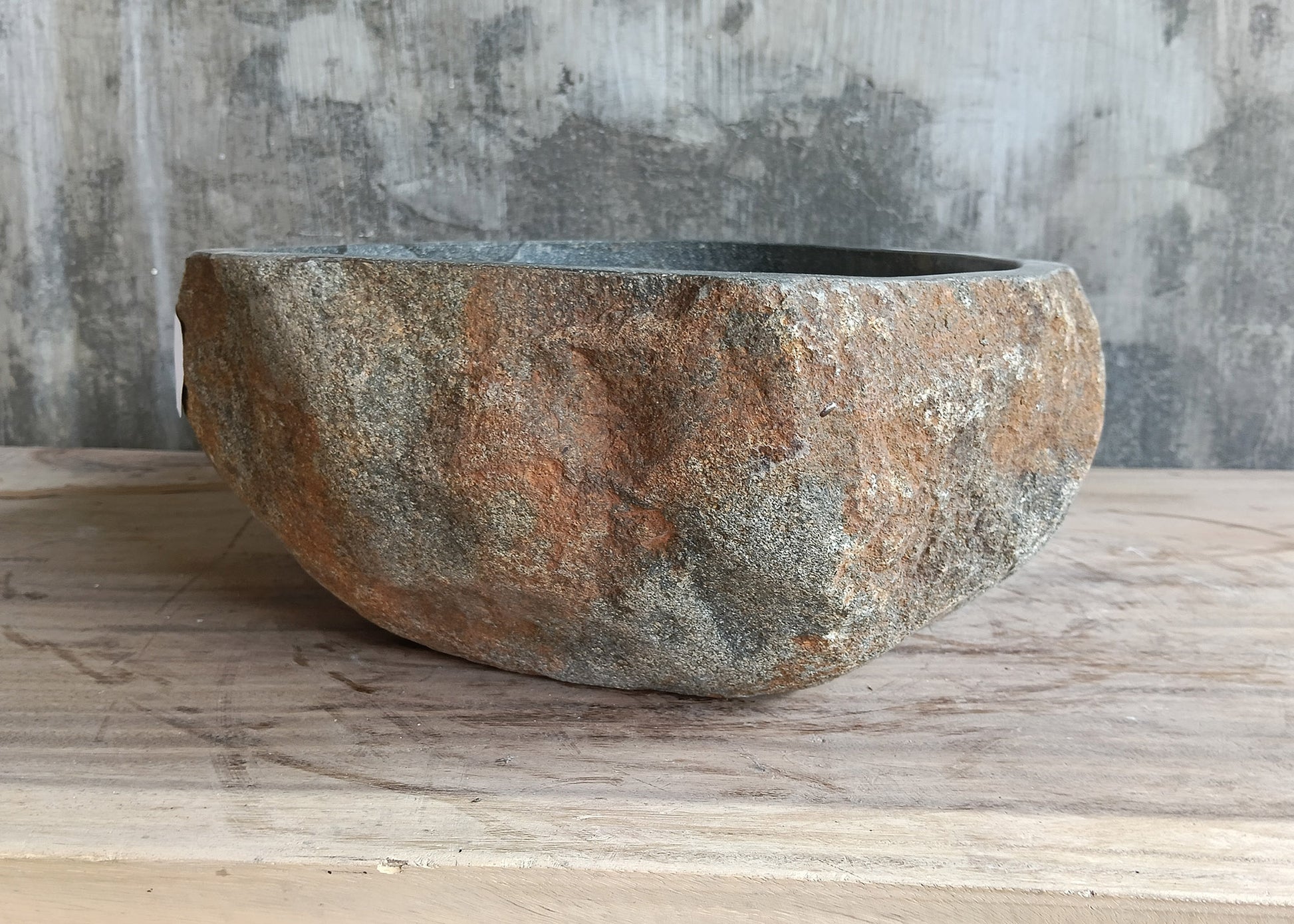 Close-up of triangular gray vessel sink highlighting natural veining and matte texture

