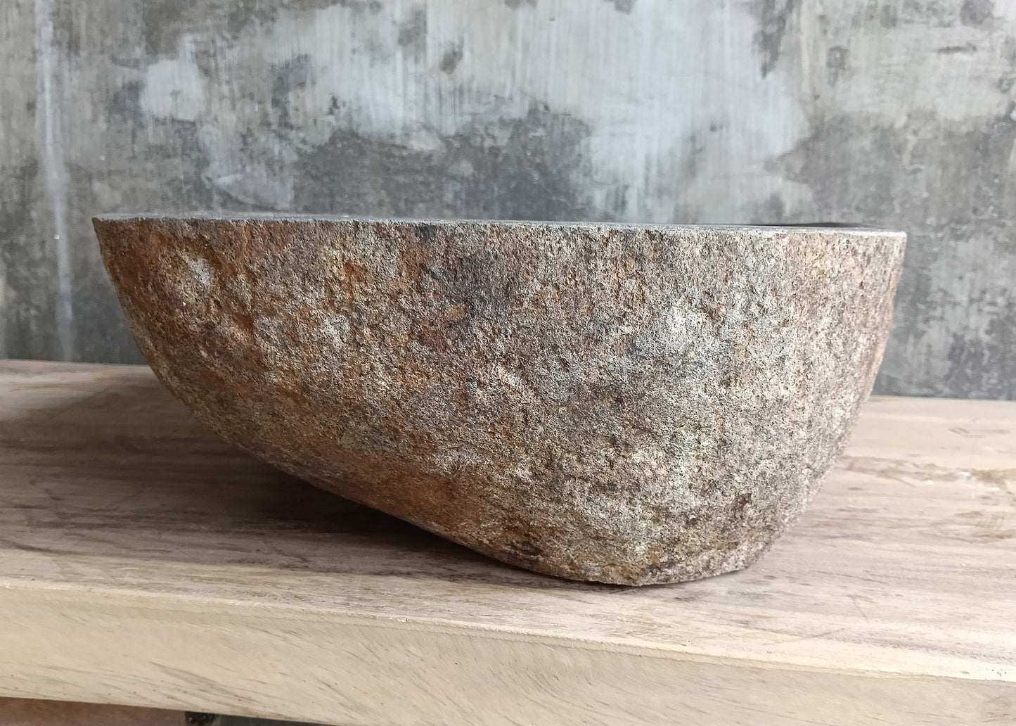 Left side view of 18×14 inch stone sink with gray textured exterior and sculpted edge

