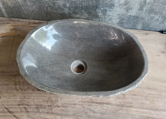 Top view of 17×12 inch gray river stone sink with elongated oval shape and smooth polished interior
