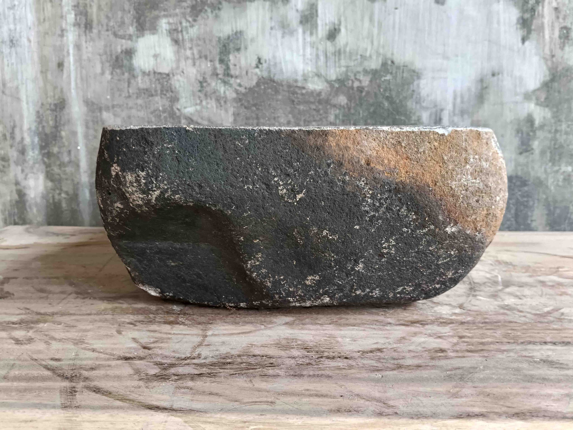 Left side view of 15×11 inch grey river stone sink in irregular form
