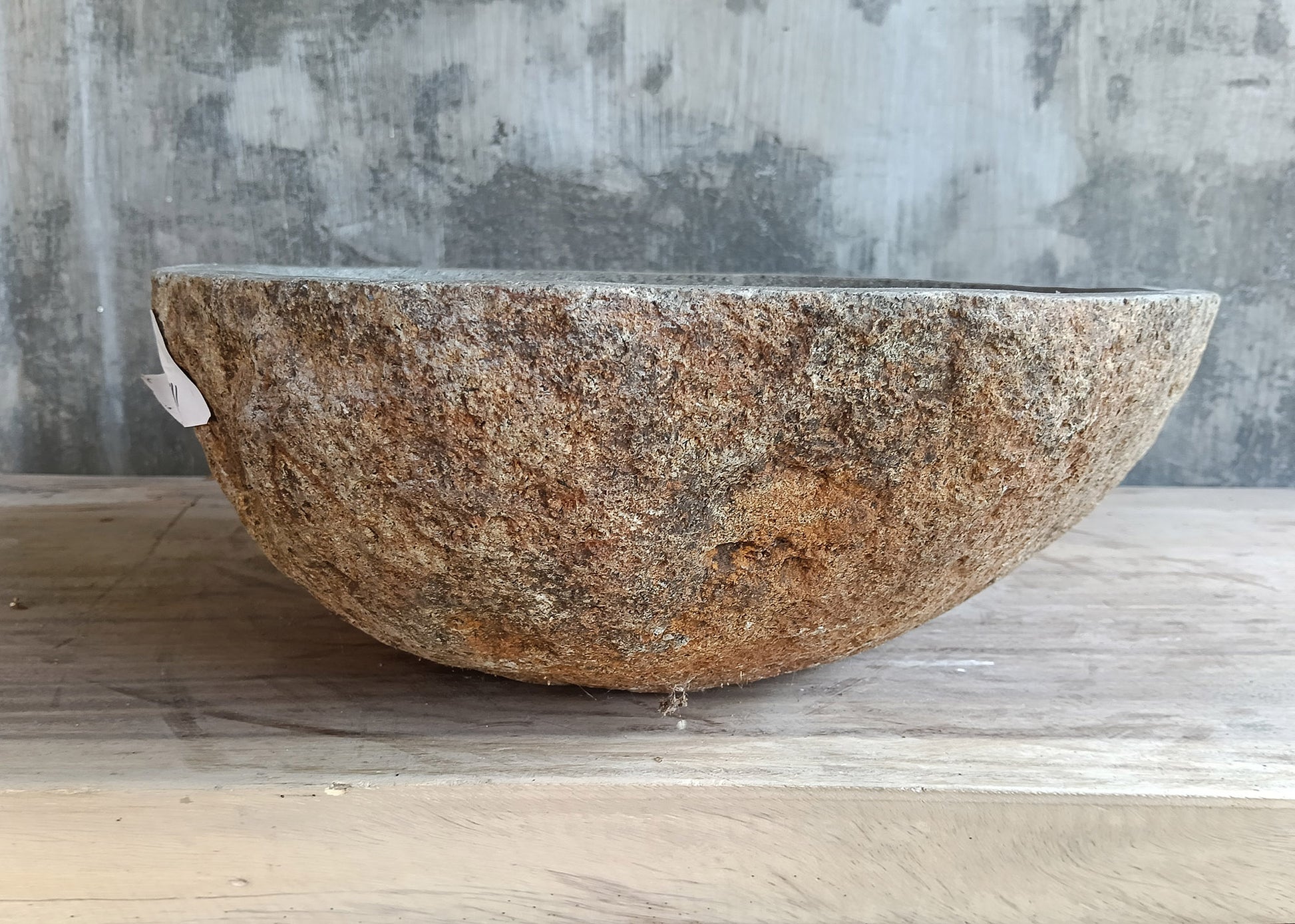 Back view of handcrafted 18×16 inch light stone sink with natural raw reddish texture
