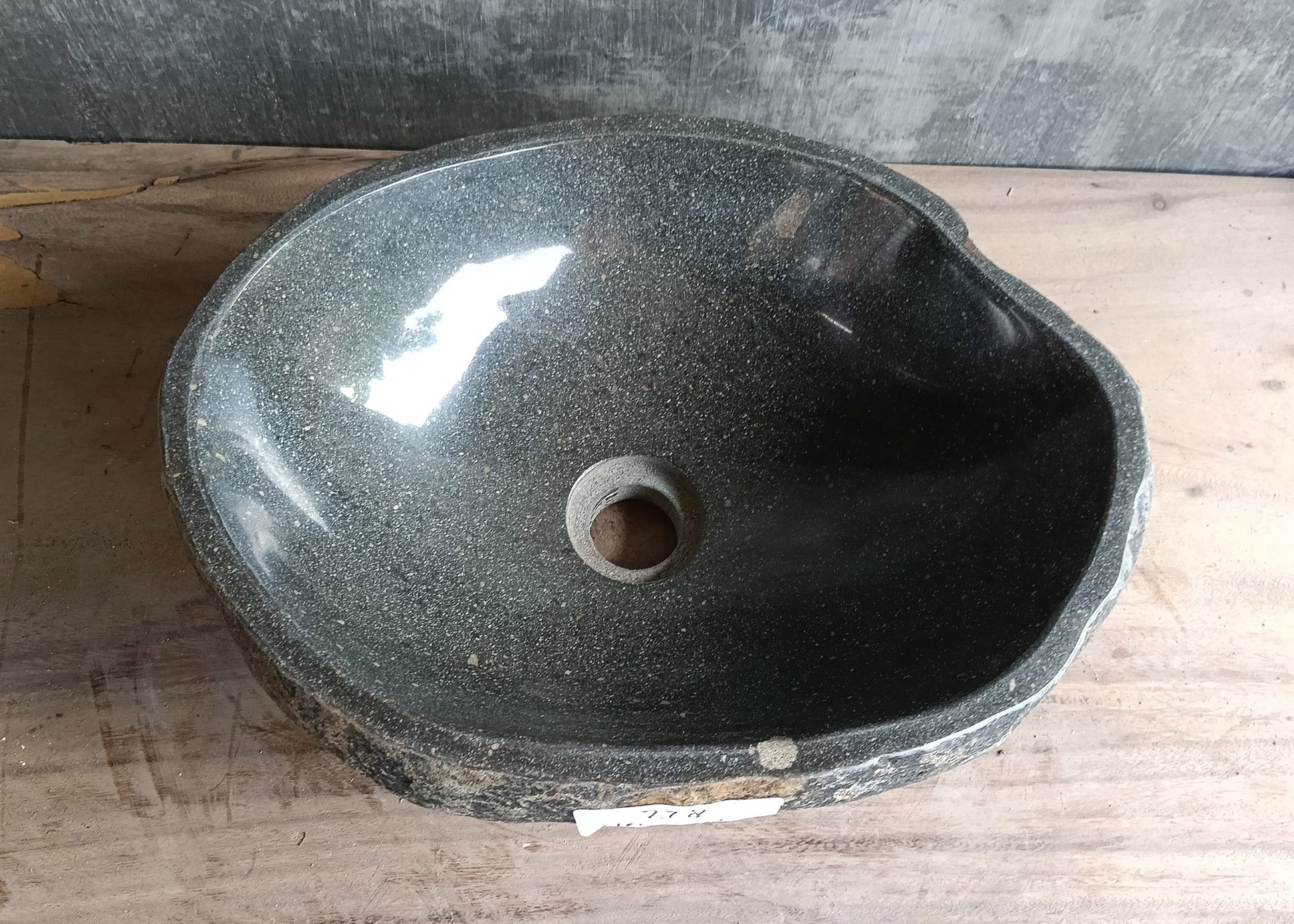 Top view of 16×12 inch dark gray river stone sink with smooth oval shape and polished interior
