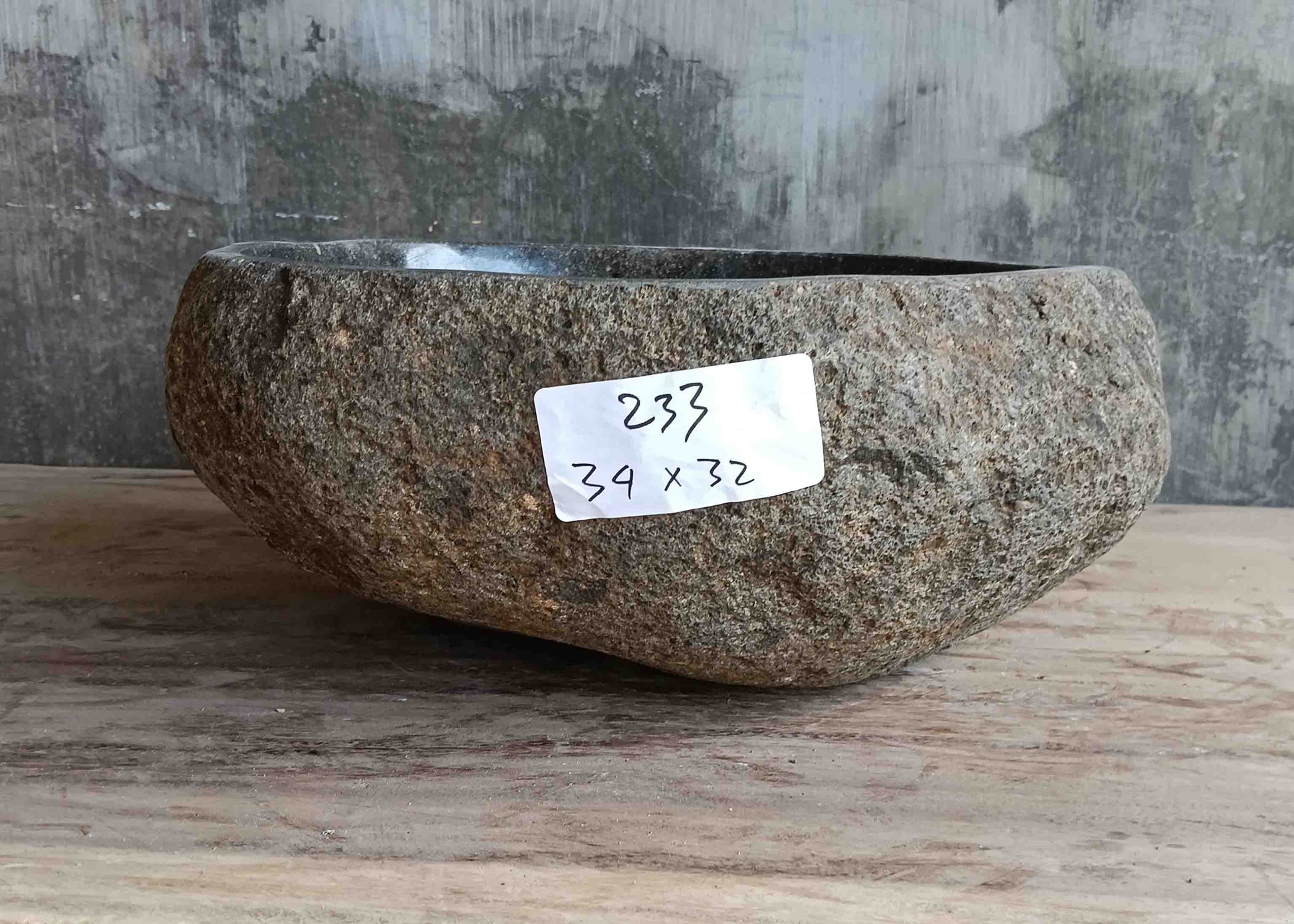 Right side view of 13×13 inch grey-brown river stone sink installed in countertop
