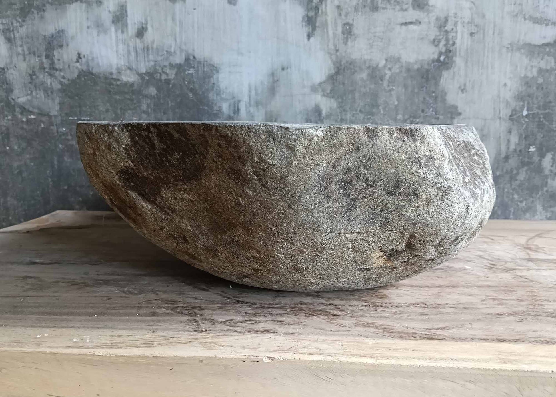 Side profile of triangular river stone sink 6237-5336 with polished inner bowl and rugged exterior
