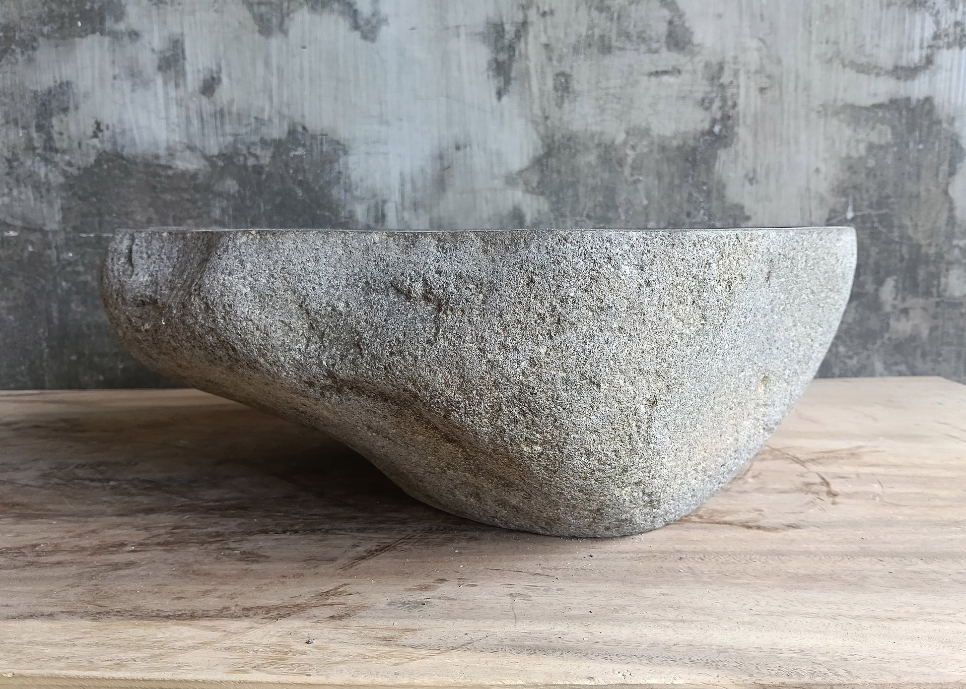 Right view of gray river stone sink highlighting its asymmetrical form
