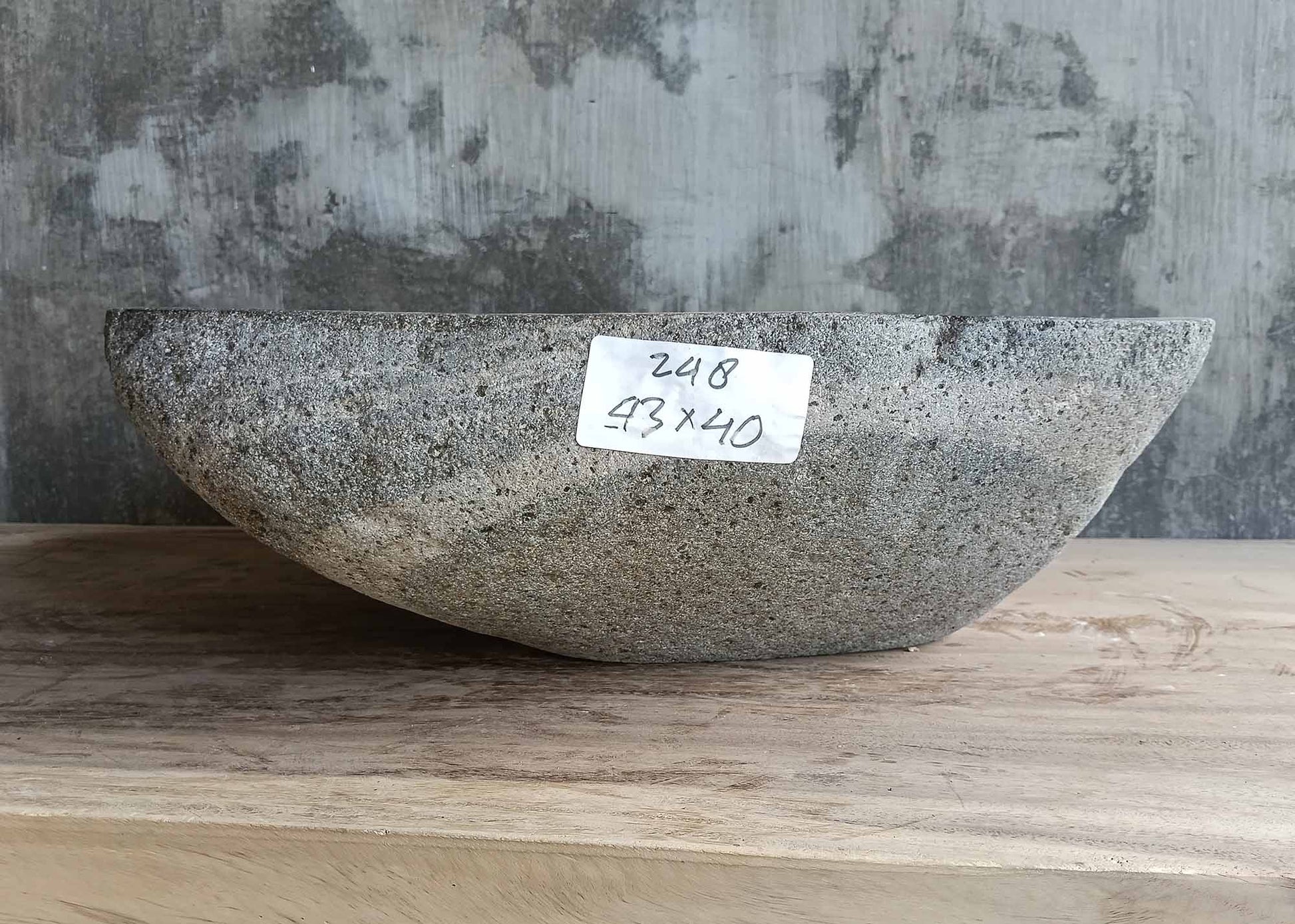 Back view of stone bathroom sink with unique stripe texture and raw finish
