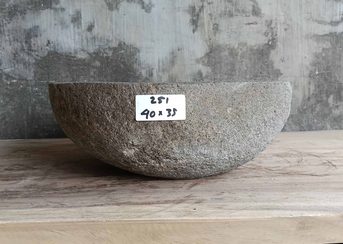 Back view of gray river stone sink showing rugged stone surface
