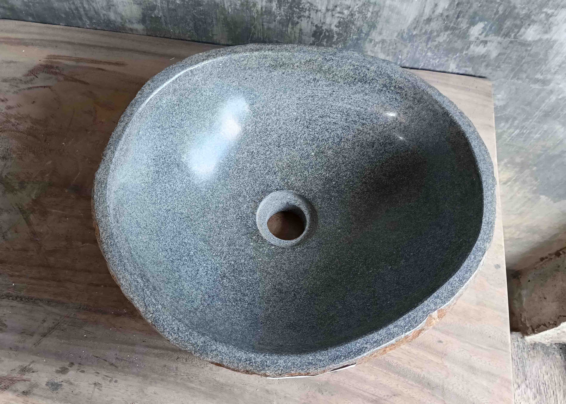 Top view of handcrafted grey 15×13 inch river stone sink in oval boat-like form
