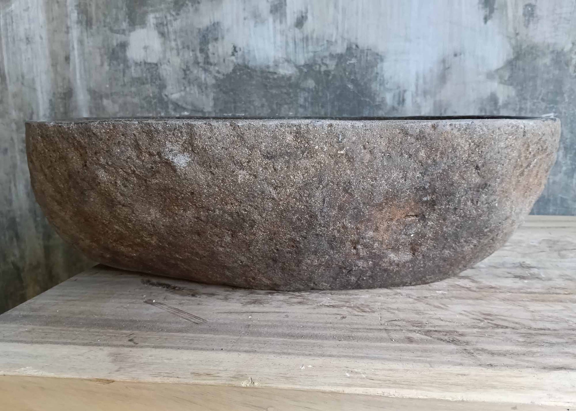 Back view of asymmetric elongated river stone sink
