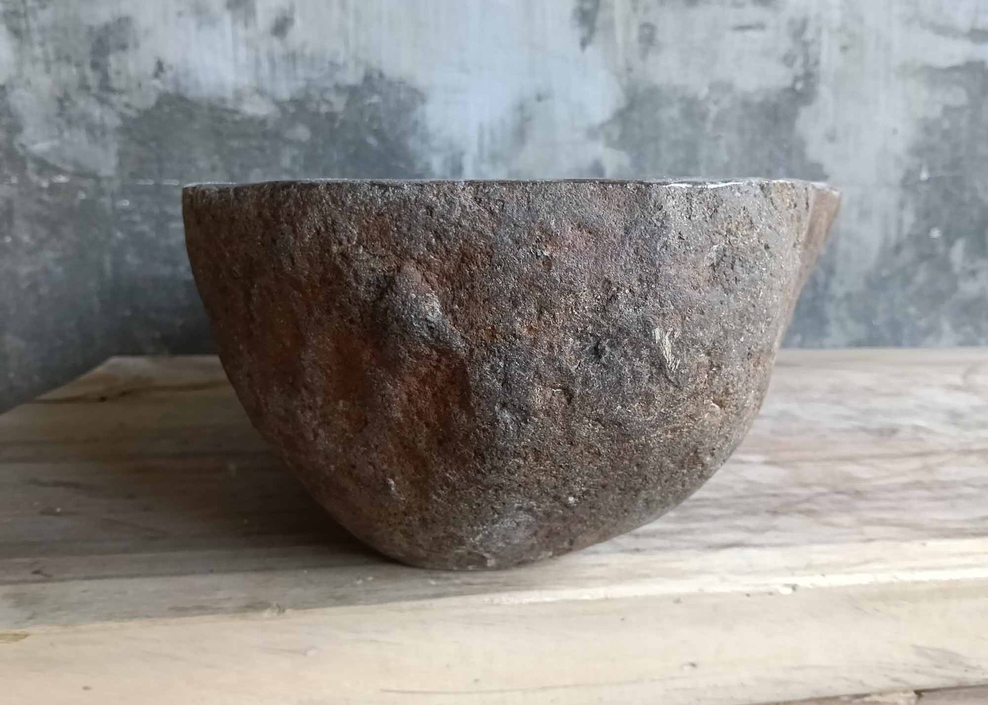Side angle showing irregular stone texture and deep bowl
