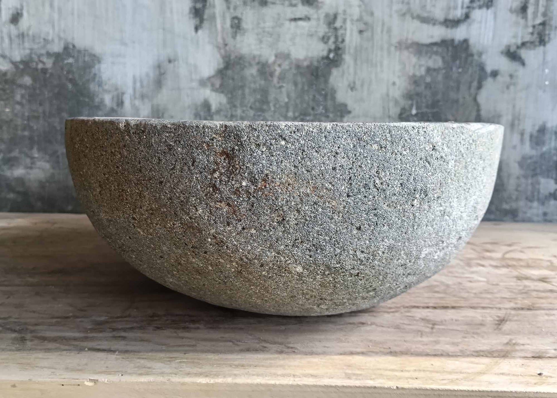 Side profile of gray river stone sink with smooth finish
