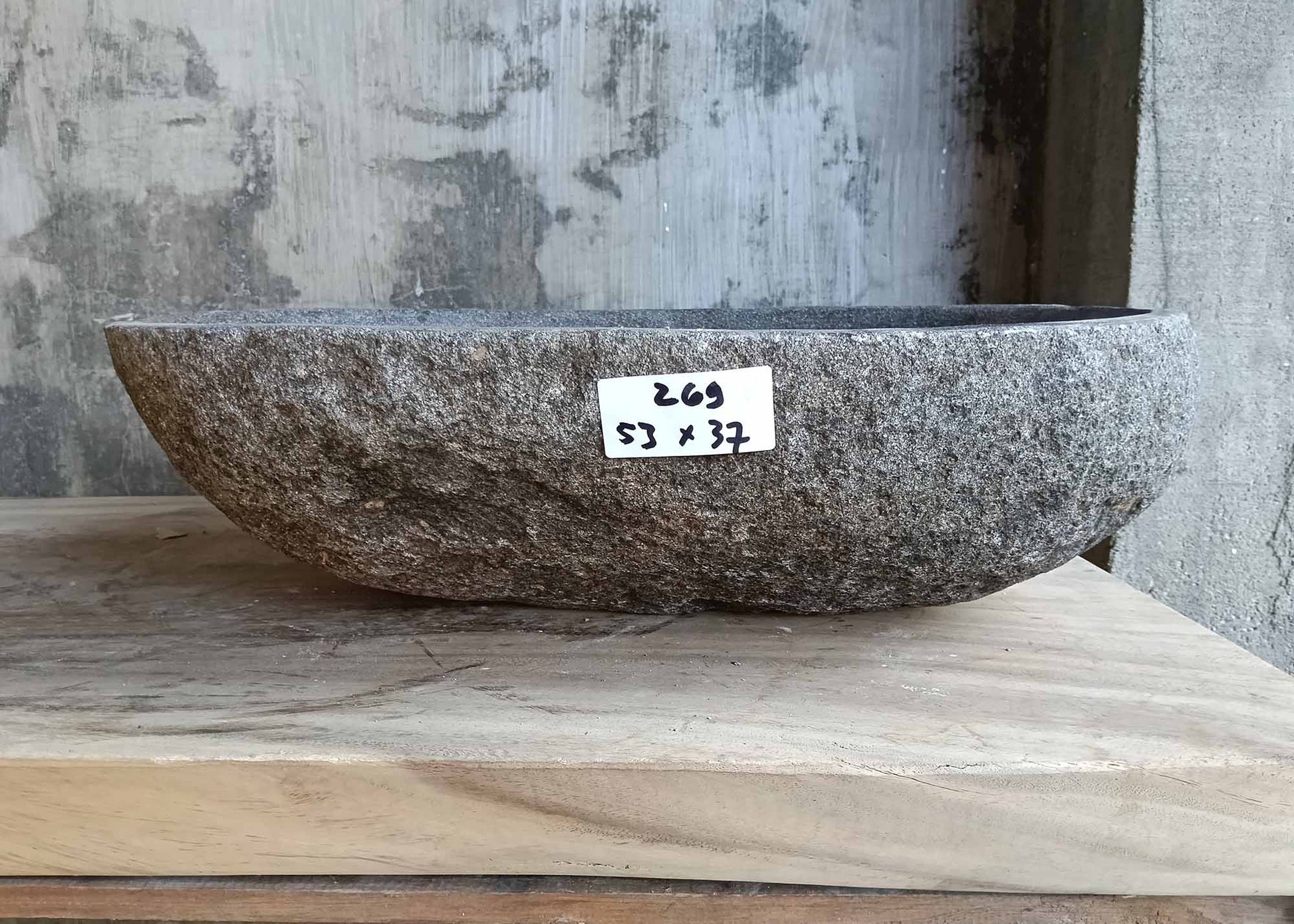 Front view of handcrafted sink 6269-5337 showing dark rugged exterior and organic stone texture
