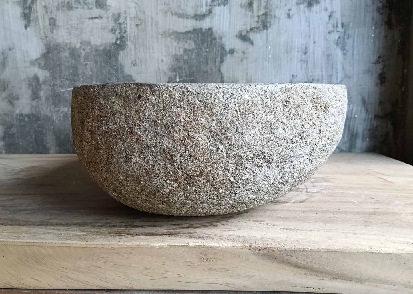 Right profile of gray handcrafted stone sink in pear shape
