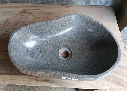 Top view of pear-shaped gray river stone sink with polished basin
