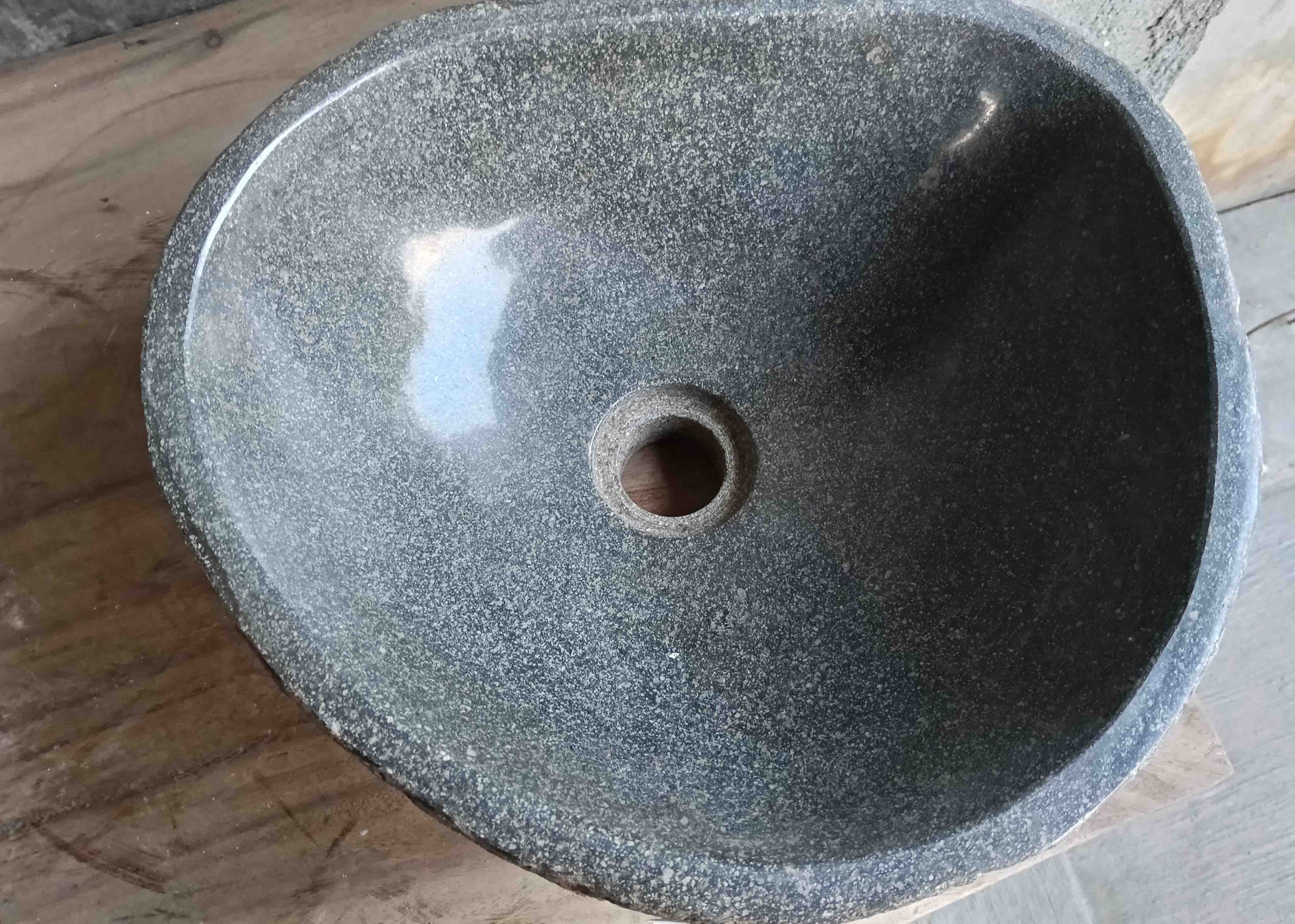 Top view of handcrafted grey 14×13 inch river stone sink in oval boat-like form
