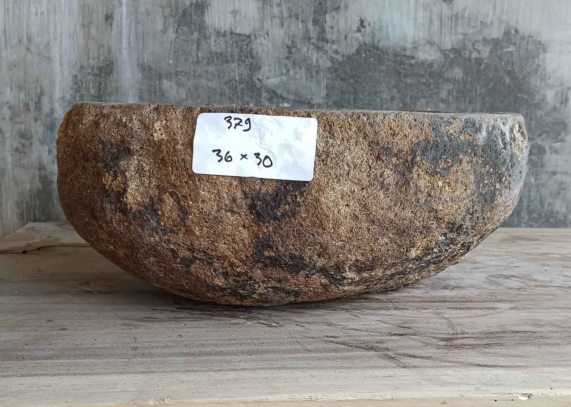 Front side view of light beige 14×12 inch river stone sink showing natural exterior texture
