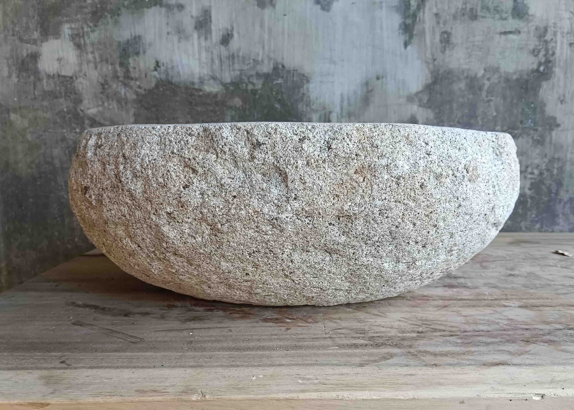 Left side view of 15×12 inch light-gray river stone sink installed in countertop
