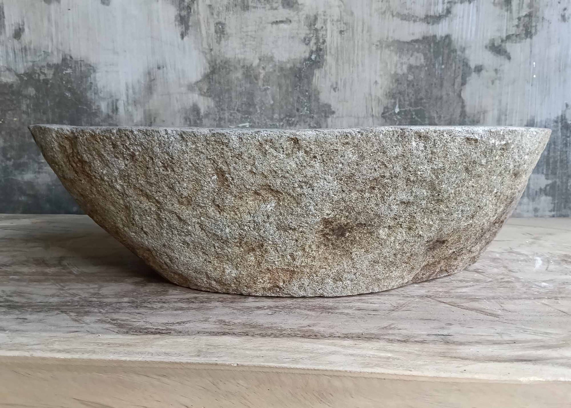 Front profile of handcrafted boat-shaped sink with natural texture
