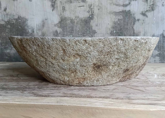Front profile of handcrafted boat-shaped sink with natural texture
