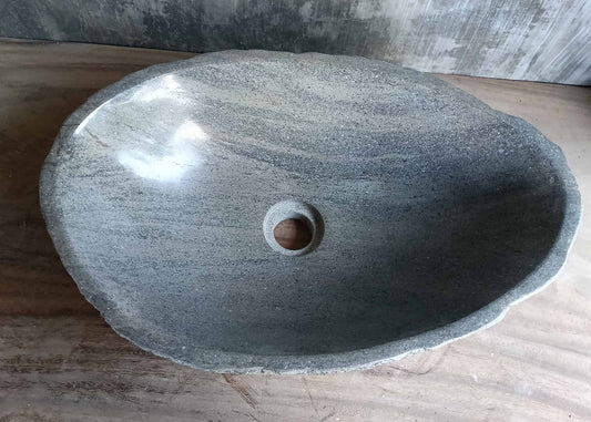 Top view of oval river stone sink with brown-gray striping

