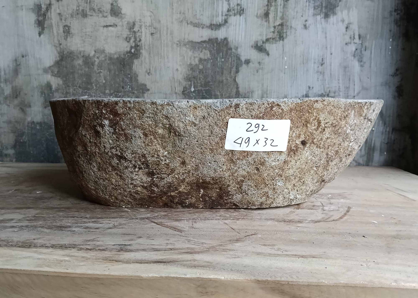 Rear view of oval striped river stone sink
