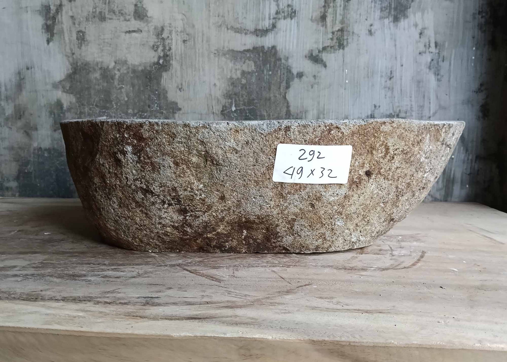 Rear view of oval striped river stone sink
