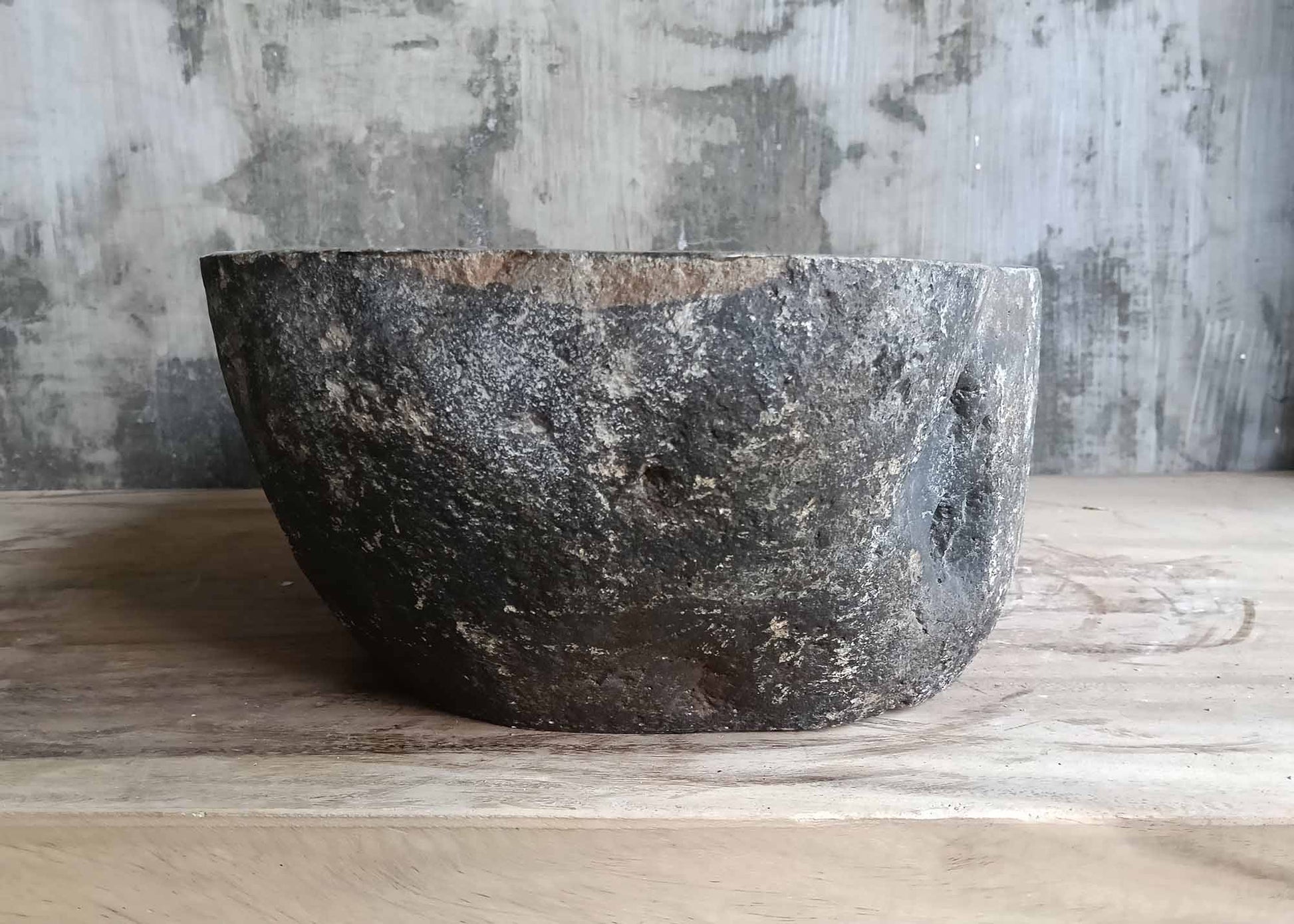 Right view of dark natural stone oval basin
