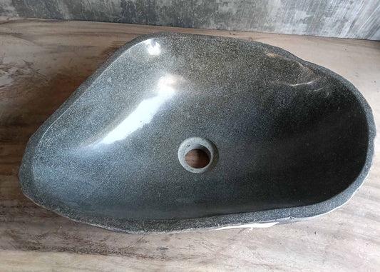 Top view of dark gray elongated river stone sink
