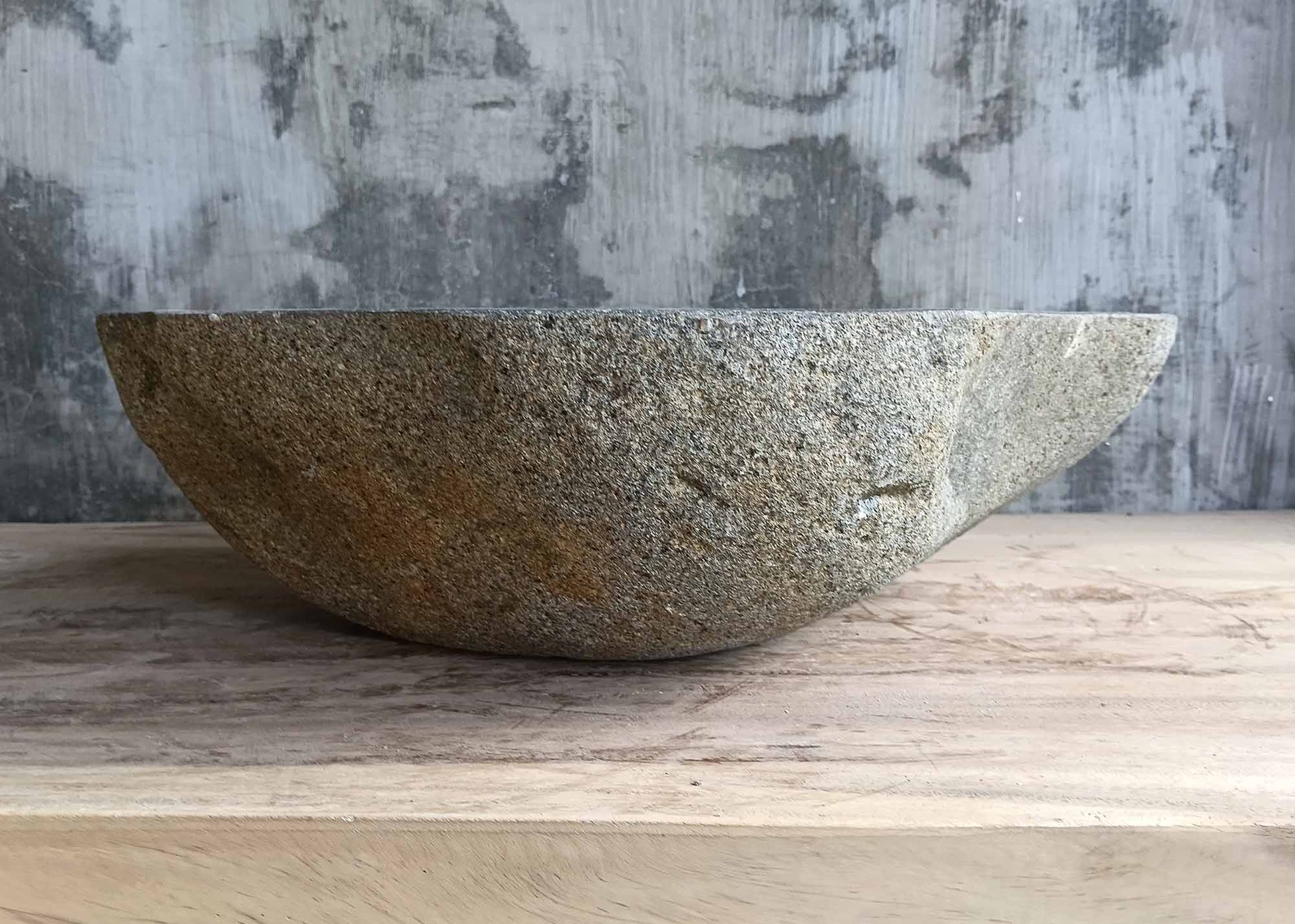 Right angle view of irregularly shaped river stone basin
