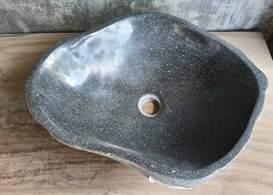Top view of irregular dark gray river stone sink
