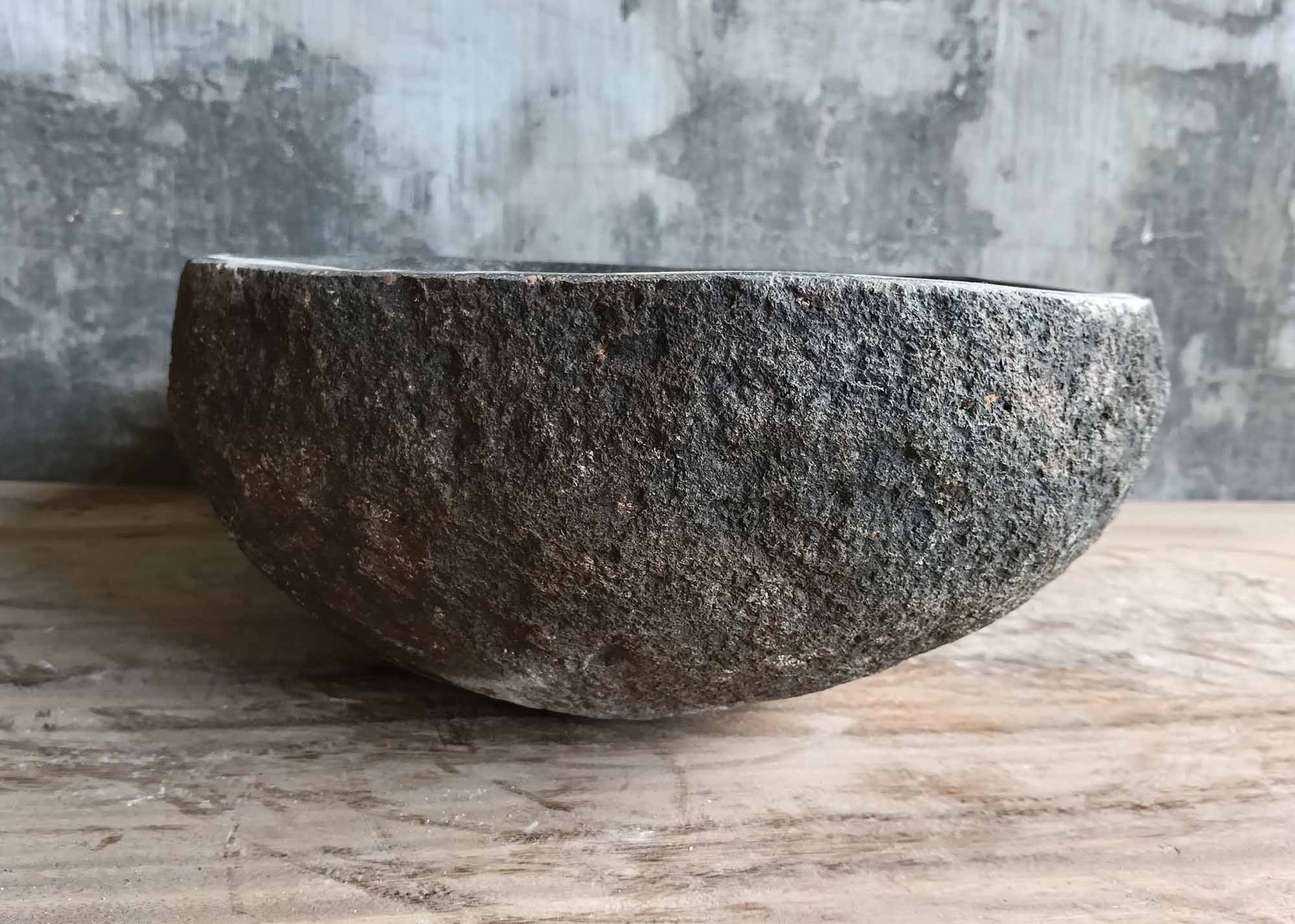 Left angle showing dark textured stone sink exterior
