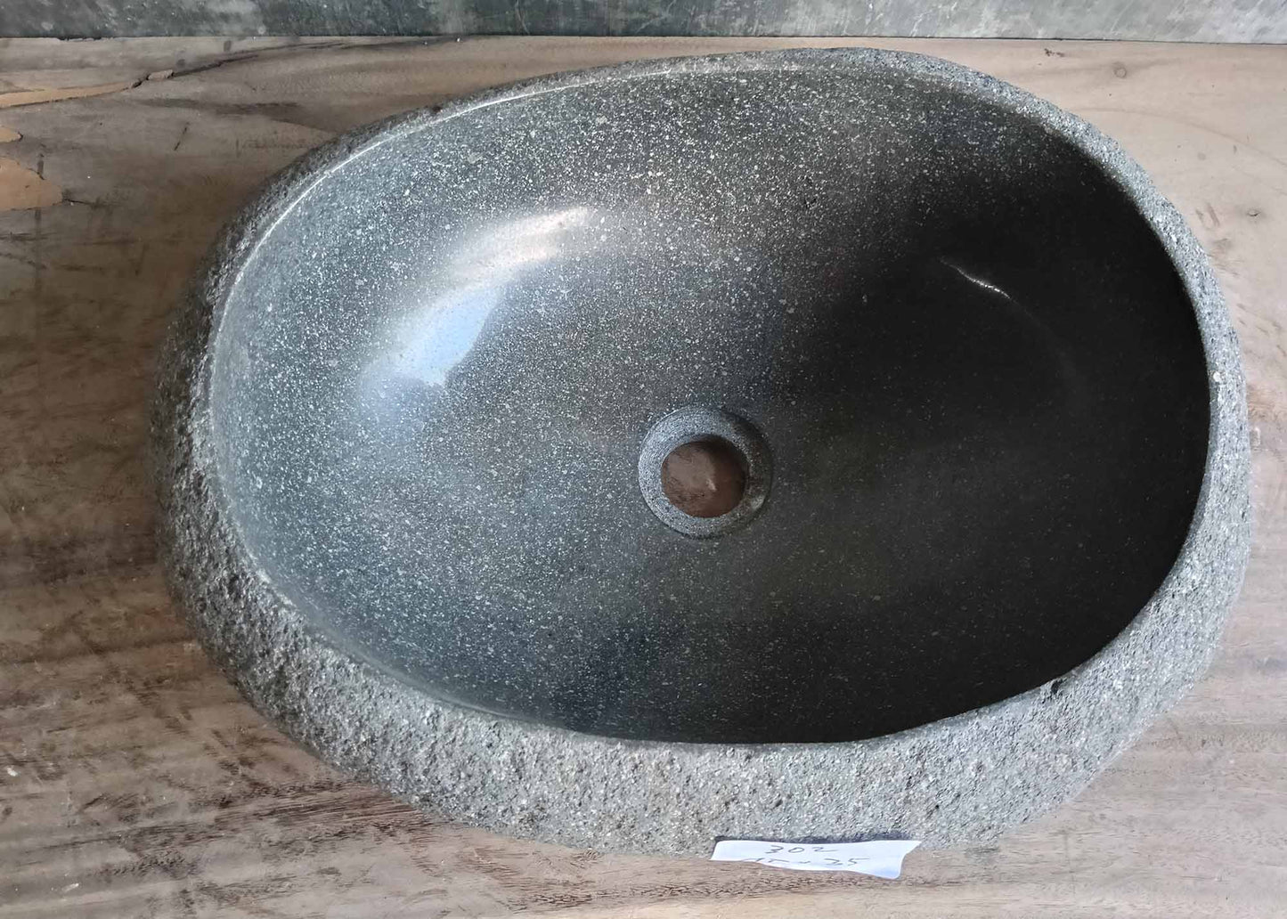 Top view of handcrafted oval gray river stone sink
