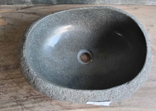 Top view of handcrafted oval gray river stone sink
