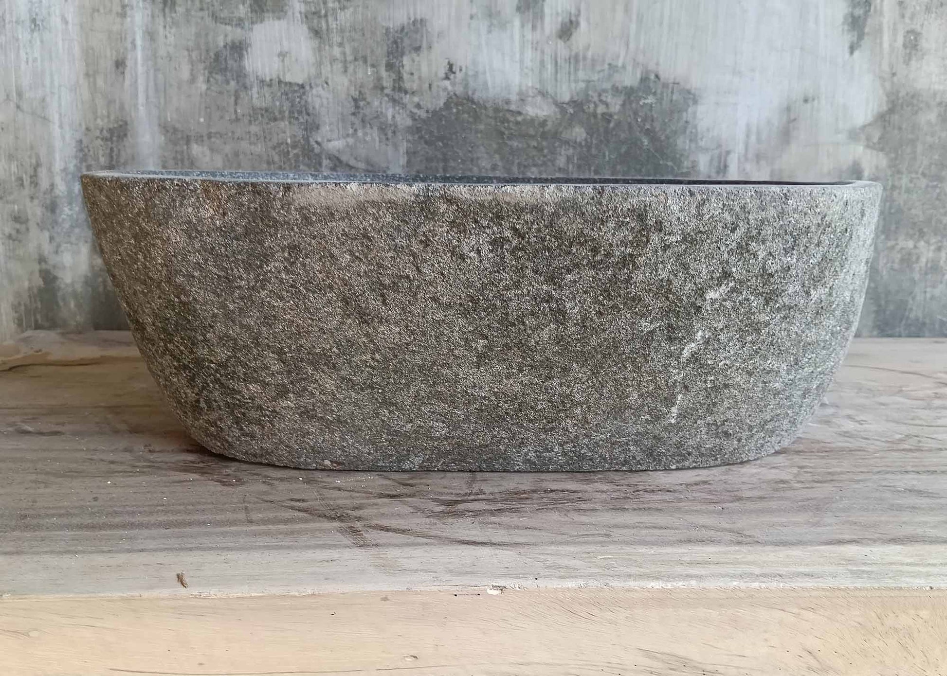 Front view showing cylindrical stone sink with natural surface
